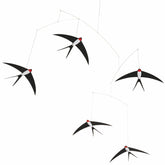 Flensted 5 swallows mobile hanging over bed for calming ambience.