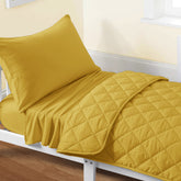 FLXXIE quilt in yellow offers a soft, cozy touch for toddler sleep