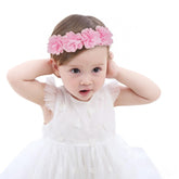 Fmeida soft pink flower headband on a baby girl; ideal photography prop