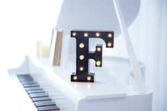 Foaky LED marquee hanging on wall for event decor.