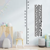Fssqii height sticker wall chart on a clean wall showing growth milestones
