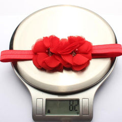 Beads accent the chiffon stamens on a FZBNSRKO headband detail.