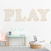 Giantree rattan letters with hexagon frame add boho charm to playroom walls