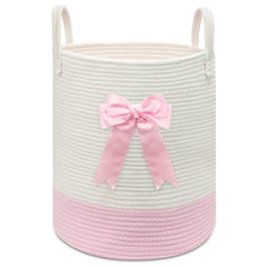 Goodheim pink woven laundry hamper with bow for nursery storage and clothes.