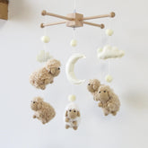 Goukurlsma sheep mobile with wood frame offers a sturdy crib focal point.