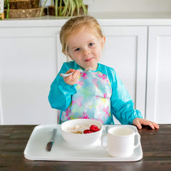 Green Sprouts roll-and-go bib with pocket for utensils on the go