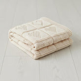 Grewear baby knit blanket with cream heart pattern for cozy crib moments