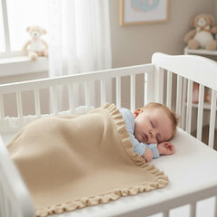 Grewear cotton baby blanket spread on crib demonstrates lightweight knit for year-round comfort.