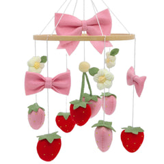 Gueiddi Strawberry Mobile for Crib featuring pink bow and strawberries enhances nursery ambience and focal point.