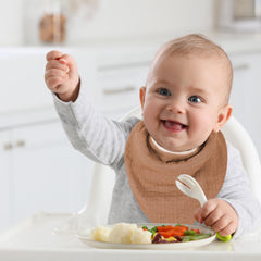 GUNTAIL adjustable closure bandana bib demonstrated on infant neck