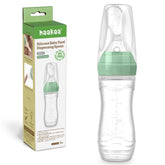 Haakaa silicone baby food dispensing spoon feeder close-up showing precise flow control for gentle feeding