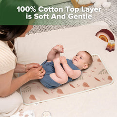 Haakaa changing pad liner folded for travel protects surfaces in a diaper bag.