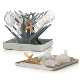 Haakaa portable bottle drying rack with tray keeps bottles organized and air-dried after washes.