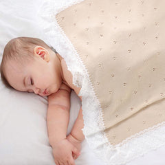 Hadetoto cotton lace-knit blanket in nursery setting showcasing lightweight warmth.