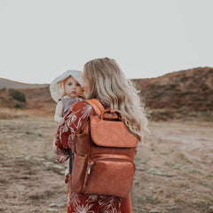 Hahasole leather diaper bag backpack open with changing mat for quick baby item access.