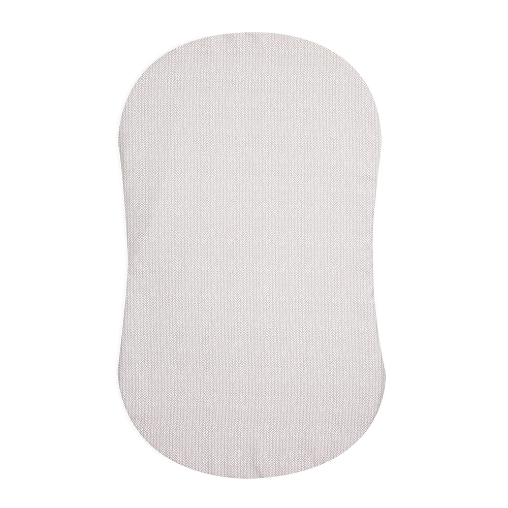 HALO BassiNest fitted sheet on pad offers secure fit and quick changes.