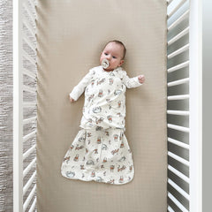 HALO Winnie Frolic Sleepsack arm-adjustment demonstrates 3-way swaddle for comfort.