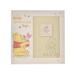 Winnie the Pooh frame with gold lettering adds an elegant keepsake for a child’s room.