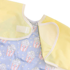 Hi Sprout sleeve bib features a catch-all pocket to keep messes off the floor.