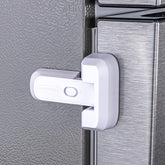HomeBrella fridge lock with adhesive pad securing doors for child safety.
