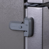 HomeBrella fridge lock with adhesive being installed on a fridge door.