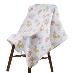 Honey Lullabies muslin blanket with dinosaurs pattern for soft baby comfort.