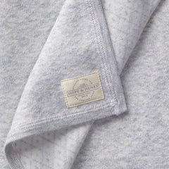 Hope & Henry Baby Jacquard Sweater Blanket folded for compact storage and warmth.