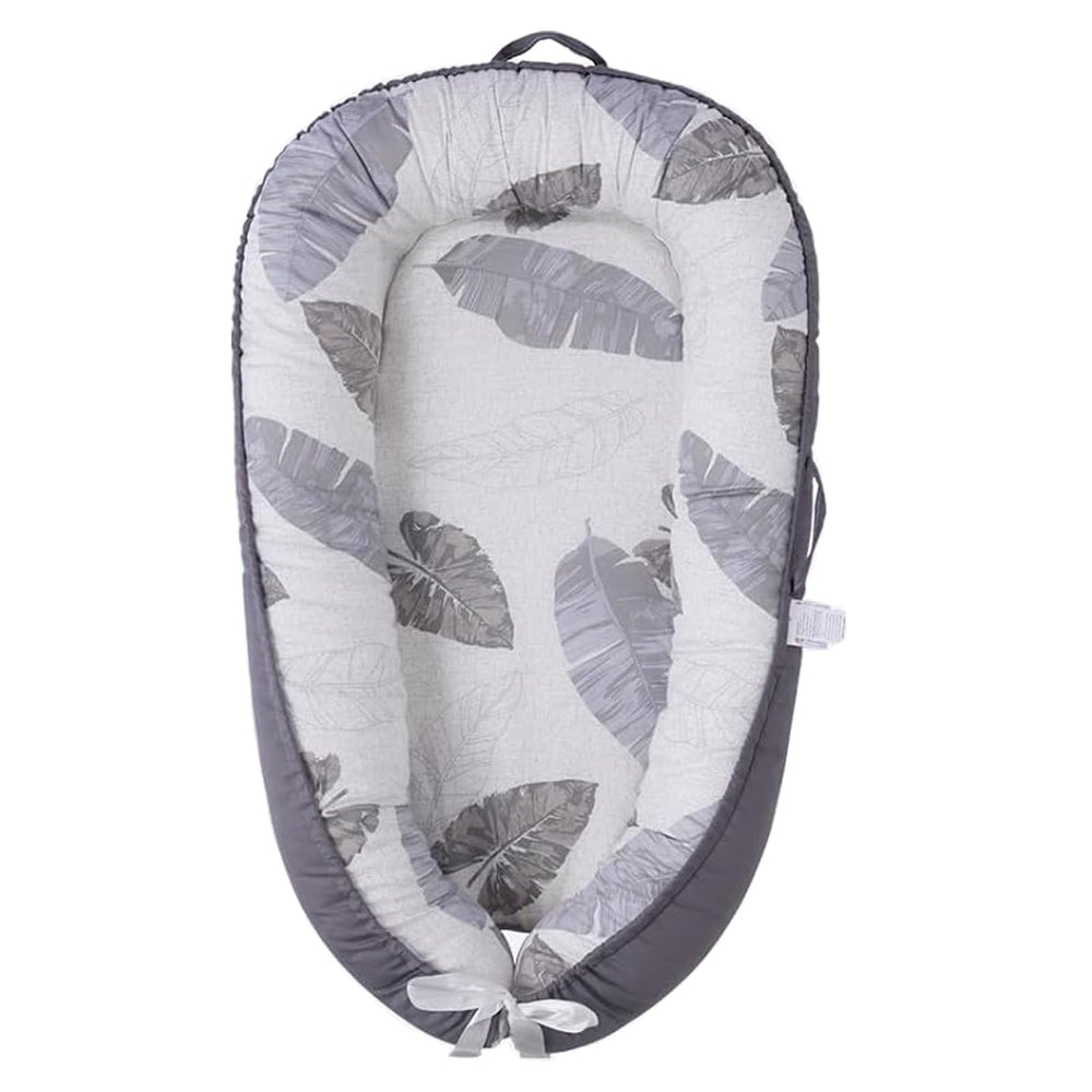 HOVIKOKI baby lounger with grey leaves cover showing soft cotton texture