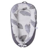HOVIKOKI baby lounger with grey leaves cover showing soft cotton texture