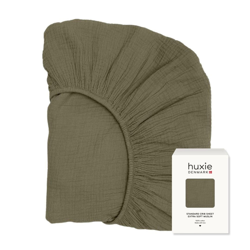Huxie organic cotton muslin crib sheet with soft, breathable texture for comfort.