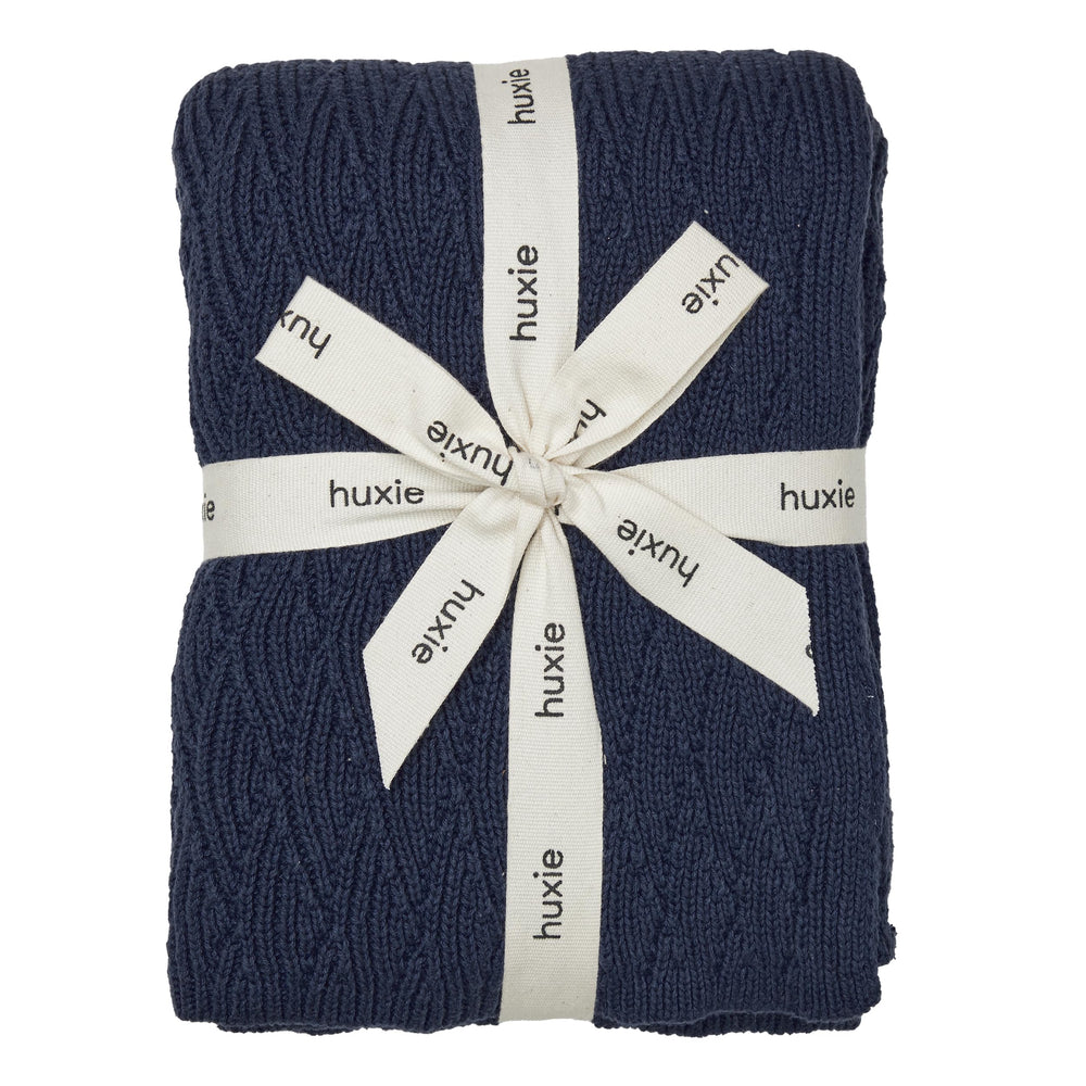 Huxie knitted baby blanket in organic cotton, exceptionally soft for newborn snuggles.