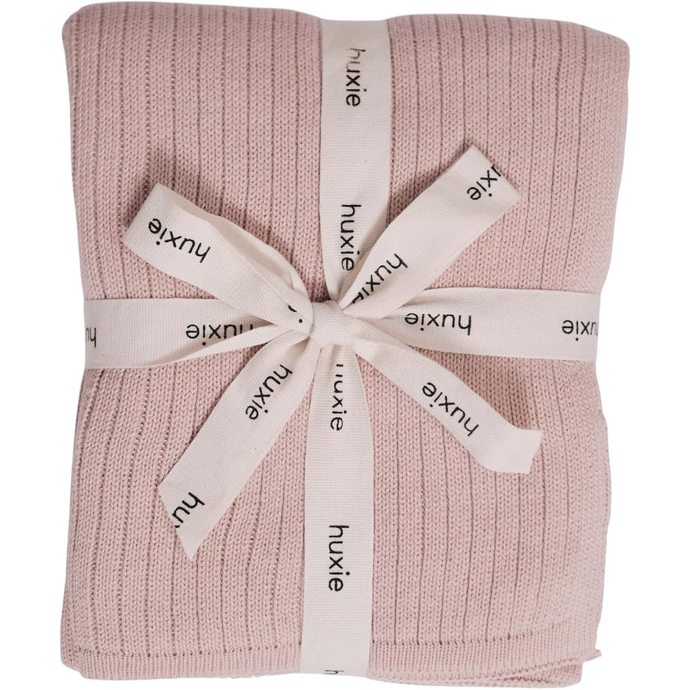 Huxie knitted baby blanket ribbed blush closeup showing soft texture for delicate skin.