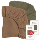 Huxie mini crib sheet in sage green shows soft organic cotton texture for comfort.