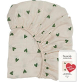 Huxie mini crib sheet in soft muslin close-up for gentle skin comfort.
