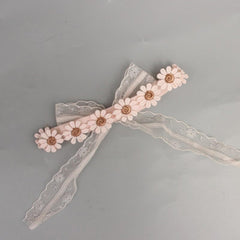 ICKEYOU lace headband closeup pink with daisy accent, soft elastic fit for newborns and toddlers.