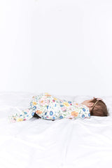 Copper Pearl Isabella swaddle blanket being used with a sleepy newborn for comfort