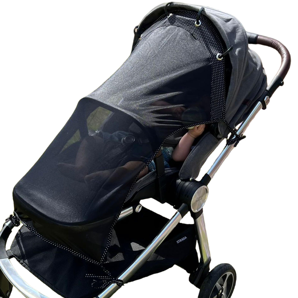 IntiMom stroller sun shade clip-on in action, quick secure attachment for universal fit.