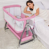 Jixrolyn pink bassinet bedside attachment with wheels for easy nighttime care.