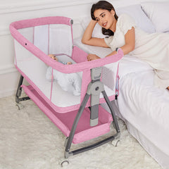 Jixrolyn pink bassinet bedside attachment with wheels for easy nighttime care.