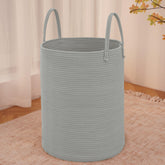 JMvicyroam large woven laundry basket in grey holding blankets and clothes.