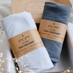 Joey + Joan light grey mini crib sheet close-up shows ultra-soft jersey cotton