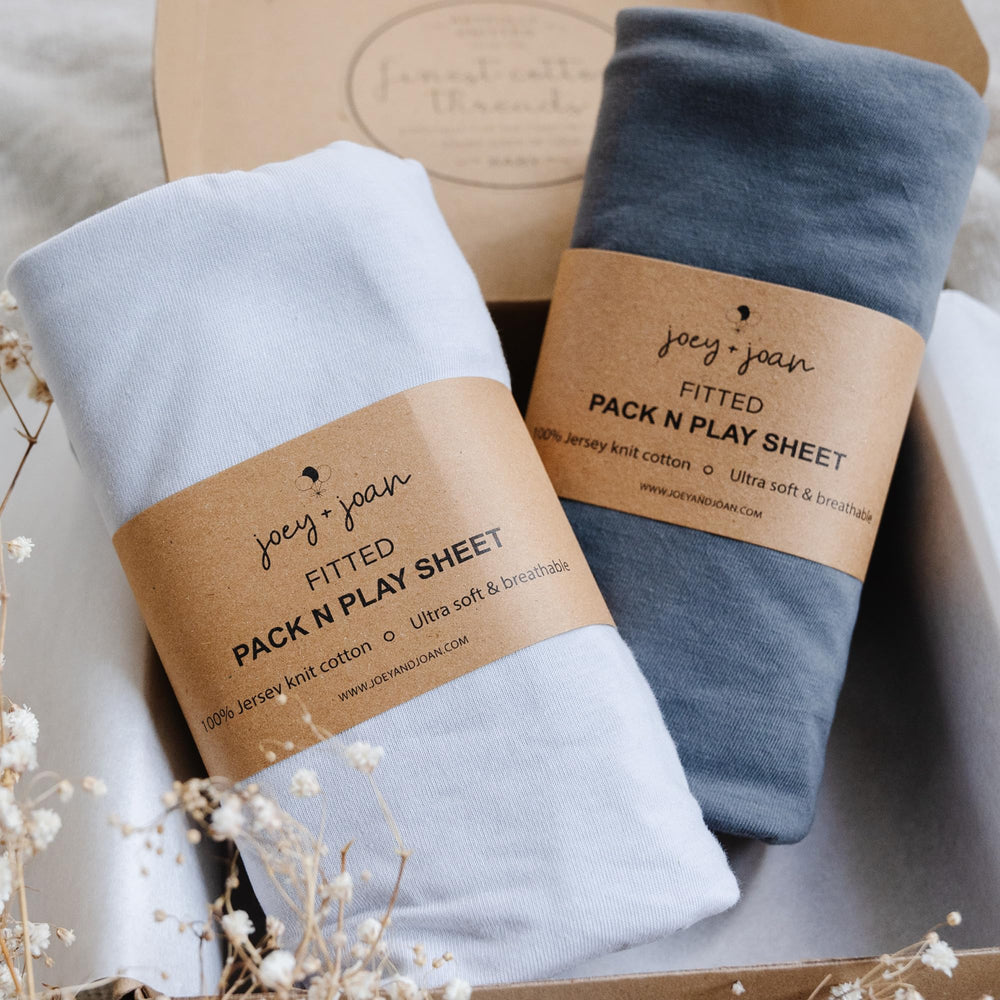 Joey + Joan pack n play sheets 2-pack on mattress, ultra-soft jersey cotton for cozy sleep.