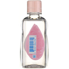 Applying Johnson & Johnson Baby Oil to a baby's skin for moisture.