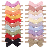 Jollybows baby bows on a cotton soft headband for gentle everyday wear.