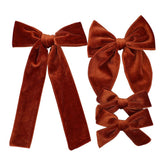 Jomila copper velvet long tail bow clip for secure daily styling.