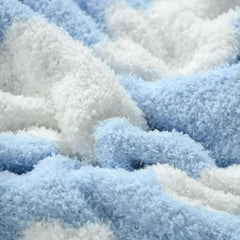 Newborn swaddling with JOOJA cloud blanket in blue knit fabric.