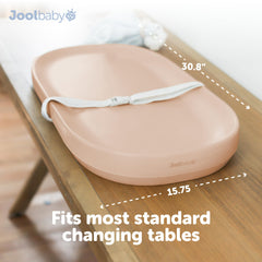 Jool Baby changing pad with raised sides and safety strap for secure changes.
