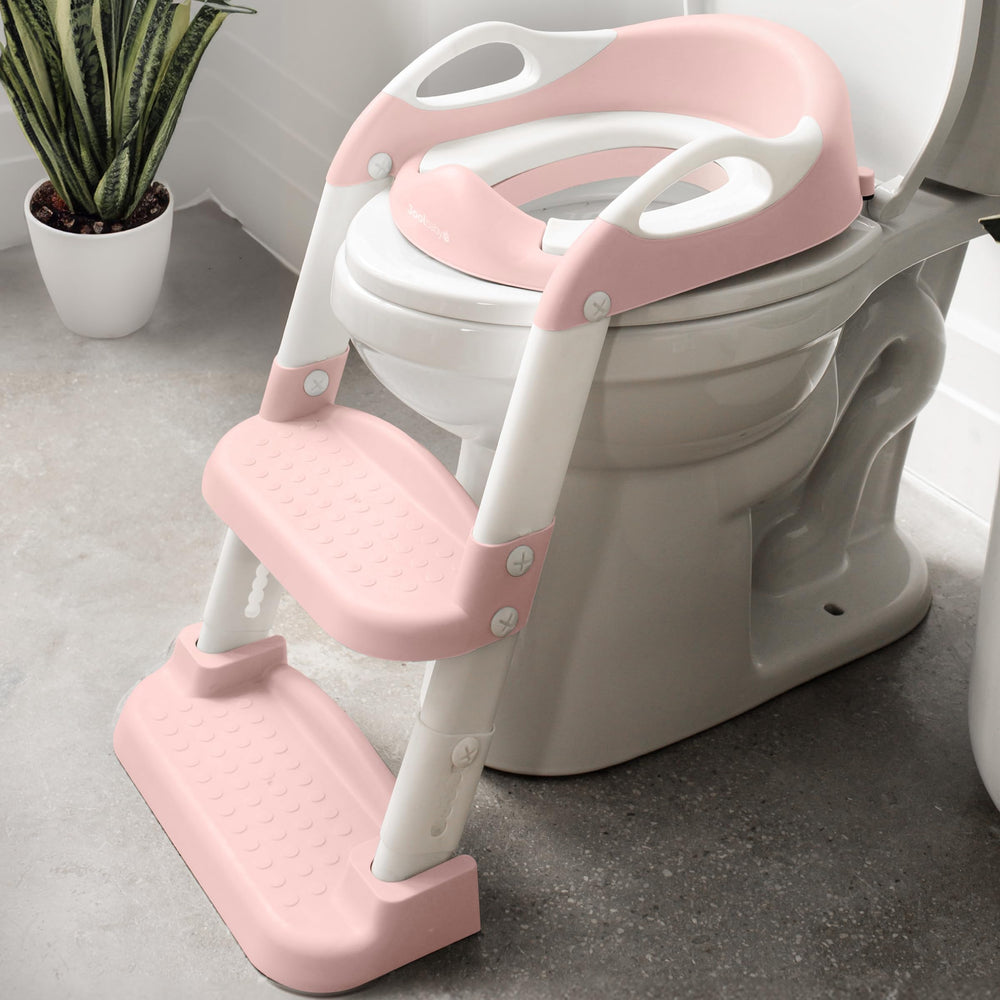 Jool Baby potty training seat with 2-step ladder in pink for independent toilet use.