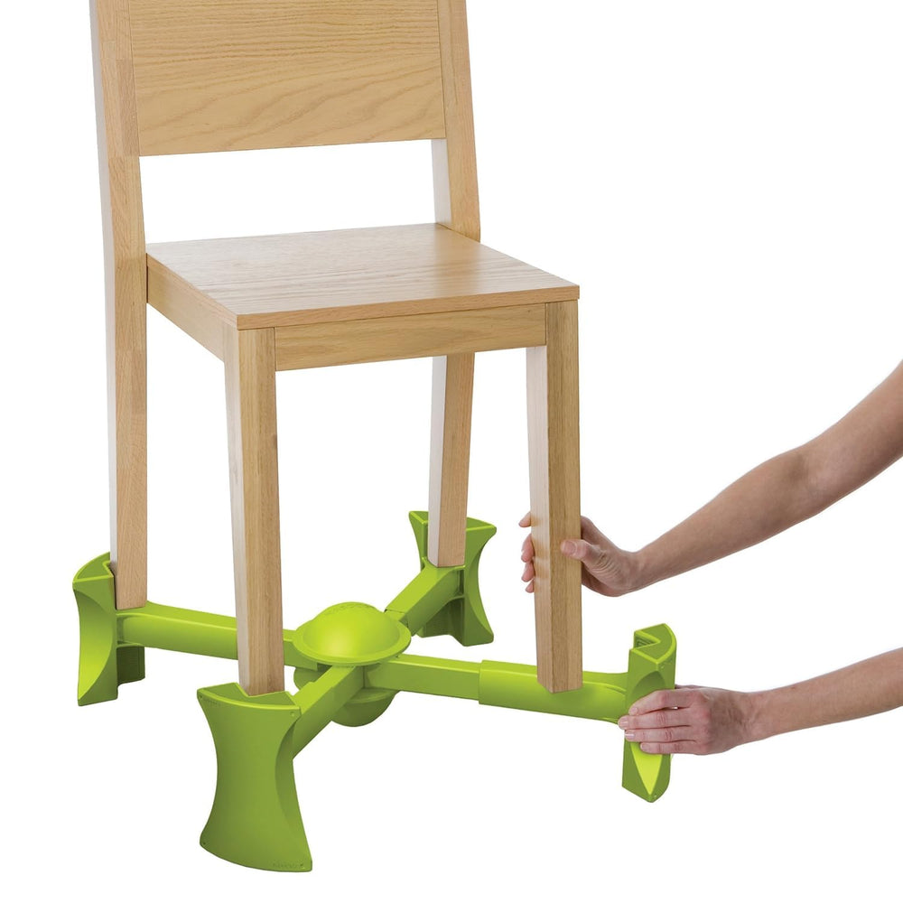 KABOOST booster seat under chair showing stable toddler seating at the table.