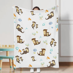 KASTLEE sea otter family print blanket adds playful nursery decor.